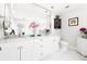 Bright bathroom with double sink vanity with marble countertops, a toilet, and storage space at 6129 Leeland S St, St Petersburg, FL 33715