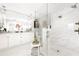 Updated bathroom with double sinks, marble countertops, a walk-in shower and a decorative shelf at 6129 Leeland S St, St Petersburg, FL 33715