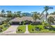 Charming home with lush landscaping, a paver driveway, and a welcoming entrance that exudes curb appeal at 6129 Leeland S St, St Petersburg, FL 33715