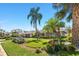 Well-maintained home featuring lush landscaping, a stone walkway, and mature palm trees at 6129 Leeland S St, St Petersburg, FL 33715