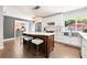 Modern kitchen with white cabinets, stainless steel appliances, and a large center island at 6129 Leeland S St, St Petersburg, FL 33715