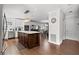 Open kitchen featuring a dark wood island, stainless steel appliances, and seamless flow to the dining area at 6129 Leeland S St, St Petersburg, FL 33715