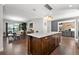 Stylish kitchen with a center island, modern lighting, and view into the dining area at 6129 Leeland S St, St Petersburg, FL 33715