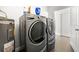 Well-equipped laundry room with a side-by-side washer and dryer plus a water heater at 6129 Leeland S St, St Petersburg, FL 33715