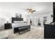 Large main bedroom featuring a ceiling fan, nightstands, and a seating area at the foot of the bed at 6129 Leeland S St, St Petersburg, FL 33715