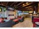 Cozy outdoor living space with a travertine floor, fireplace and TV, kitchen with stainless steel appliances, and comfortable seating at 6129 Leeland S St, St Petersburg, FL 33715