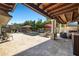 Serene backyard with a sparkling pool, covered patio, and lush landscaping, perfect for relaxation and entertainment at 6129 Leeland S St, St Petersburg, FL 33715