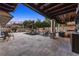 Lavish outdoor space featuring travertine flooring, a cozy fireplace, a tranquil pool, and a covered outdoor kitchen and living area at 6129 Leeland S St, St Petersburg, FL 33715