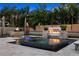 Outdoor pool area featuring fire features, tiki torches, lush landscaping, and stone patio at 6129 Leeland S St, St Petersburg, FL 33715
