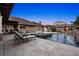 Beautiful backyard pool, travertine patio, and outdoor kitchen with a fireplace, an outdoor living area, and a pergola with seating at 6129 Leeland S St, St Petersburg, FL 33715