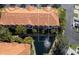 Stunning aerial view of residences with lush landscaping, serene water feature, and beautiful Mediterranean-style architecture at 6303 Vista Verde E Dr, Gulfport, FL 33707