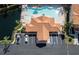 Aerial view of a building with a pool and parking lot with palm trees and lush greenery at 6303 Vista Verde E Dr, Gulfport, FL 33707