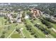 Aerial shot captures a community adjacent to a golf course, complete with tree-lined streets and manicured greens at 6303 Vista Verde E Dr, Gulfport, FL 33707