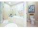 Bright bathroom featuring a soaking tub with glass shower and tropical decor at 6303 Vista Verde E Dr, Gulfport, FL 33707