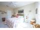 Comfortable bedroom featuring a patterned bedspread, ceiling fan, and a window with plantation shutters at 6303 Vista Verde E Dr, Gulfport, FL 33707