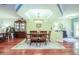 Bright dining room with hardwood floors, tray ceiling, and a decorative area rug at 6303 Vista Verde E Dr, Gulfport, FL 33707