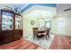 Elegant dining room with tray ceiling, hardwood floors, and a large china cabinet at 6303 Vista Verde E Dr, Gulfport, FL 33707