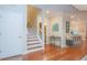 Elegant foyer with wood floors, staircase, and decorative table, leading to the kitchen at 6303 Vista Verde E Dr, Gulfport, FL 33707