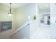 Hallway featuring a staircase, decorative light fixtures, and a view of the upstairs layout at 6303 Vista Verde E Dr, Gulfport, FL 33707