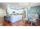 Kitchen featuring stainless steel appliances, white cabinets and blue accent wall leading into the dining room at 6303 Vista Verde E Dr, Gulfport, FL 33707