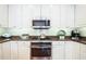 Well-lit kitchen with stainless steel appliances and white cabinets at 6303 Vista Verde E Dr, Gulfport, FL 33707