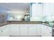 Spacious kitchen with white cabinetry, granite countertops, and an open view to the living area at 6303 Vista Verde E Dr, Gulfport, FL 33707