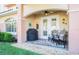 Exterior lanai featuring comfortable seating, grill, ceiling fan, and manicured landscaping at 6303 Vista Verde E Dr, Gulfport, FL 33707