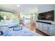 Open-concept living room featuring a modern kitchen, hardwood floors, and comfortable furnishings at 6303 Vista Verde E Dr, Gulfport, FL 33707