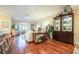 Open-concept area with hardwood floors, a china cabinet, and views of the living room and kitchen at 6303 Vista Verde E Dr, Gulfport, FL 33707
