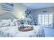 Bright, coastal bedroom with a large bed, shuttered windows, and decorative accessories at 6303 Vista Verde E Dr, Gulfport, FL 33707