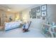 Spacious main bedroom showcasing carpet, beach decor, side chair, and view into the main bathroom at 6303 Vista Verde E Dr, Gulfport, FL 33707