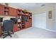Cozy home office featuring custom wood built-ins and plush carpeting at 6303 Vista Verde E Dr, Gulfport, FL 33707
