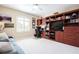 Spacious office featuring custom built-ins with a tv, work area and plenty of storage and style at 6303 Vista Verde E Dr, Gulfport, FL 33707