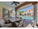 Covered patio with table and chairs overlooking the sparkling community pool at 6303 Vista Verde E Dr, Gulfport, FL 33707