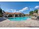 Community pool featuring inviting blue water and lounge chairs under a clear sky at 6303 Vista Verde E Dr, Gulfport, FL 33707