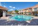 Community pool area with lounge chairs under a clear blue sky at 6303 Vista Verde E Dr, Gulfport, FL 33707