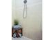 Tile shower features a rain shower head, a bench, and convenient shelving for accessories at 6303 Vista Verde E Dr, Gulfport, FL 33707