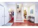 View of a staircase leading upstairs with wood flooring, a closet, and a half bathroom nearby at 6303 Vista Verde E Dr, Gulfport, FL 33707