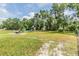 Spacious backyard with a playground, shed, and ample room for entertainment, surrounded by mature trees at 6702 Towhe Dr, Seffner, FL 33584