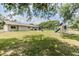 Expansive backyard with mature trees, play structures, and ample space for outdoor activities at 6702 Towhe Dr, Seffner, FL 33584