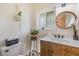 Well-lit bathroom featuring a wooden vanity with a marble countertop and decorative touches at 6702 Towhe Dr, Seffner, FL 33584