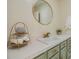 Bathroom featuring a white vanity top, gold fixtures, and a round mirror at 6702 Towhe Dr, Seffner, FL 33584