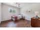 Bedroom with a window for natural light, wood look tile floors and light neutral walls at 6702 Towhe Dr, Seffner, FL 33584