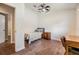 Bedroom featuring wood look tile floors, neutral walls, a ceiling fan and natural light at 6702 Towhe Dr, Seffner, FL 33584