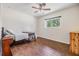 Bedroom with wood look tile floors, neutral walls and natural light from the window at 6702 Towhe Dr, Seffner, FL 33584