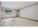Tiled bonus room with a large window offering outdoor views and a door leading to the exterior at 6702 Towhe Dr, Seffner, FL 33584