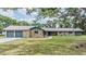 Charming stone home featuring an attached two-car garage and a well-manicured lawn at 6702 Towhe Dr, Seffner, FL 33584