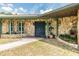 Inviting stone facade entryway with a blue front door and decorative landscaping accents at 6702 Towhe Dr, Seffner, FL 33584