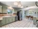 Bright kitchen featuring stainless steel appliances, tile countertops, and an adjacent dining area at 6702 Towhe Dr, Seffner, FL 33584