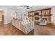 Spacious living room with wood floors, stone fireplace, and neutral-toned modern furniture at 6702 Towhe Dr, Seffner, FL 33584